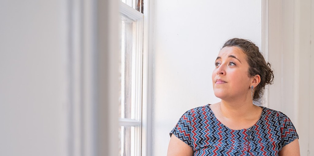 Photo of Dr Amy D'Sa looking out of a window